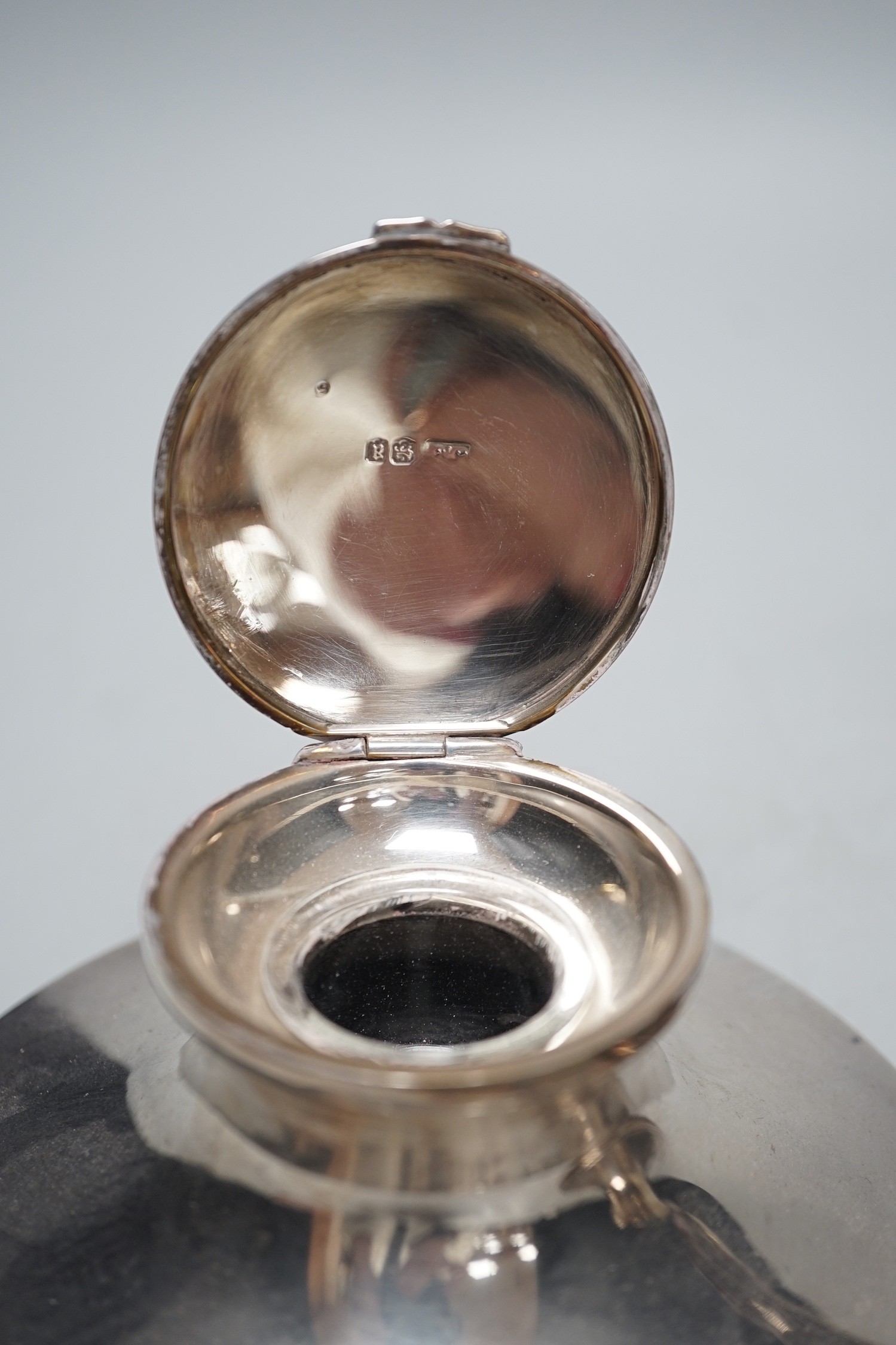 A George V silver mounted capstan inkwell, by Mappin & Webb, London, 1916, diameter 13.6cm and one other silver mounted capstan inkwell.